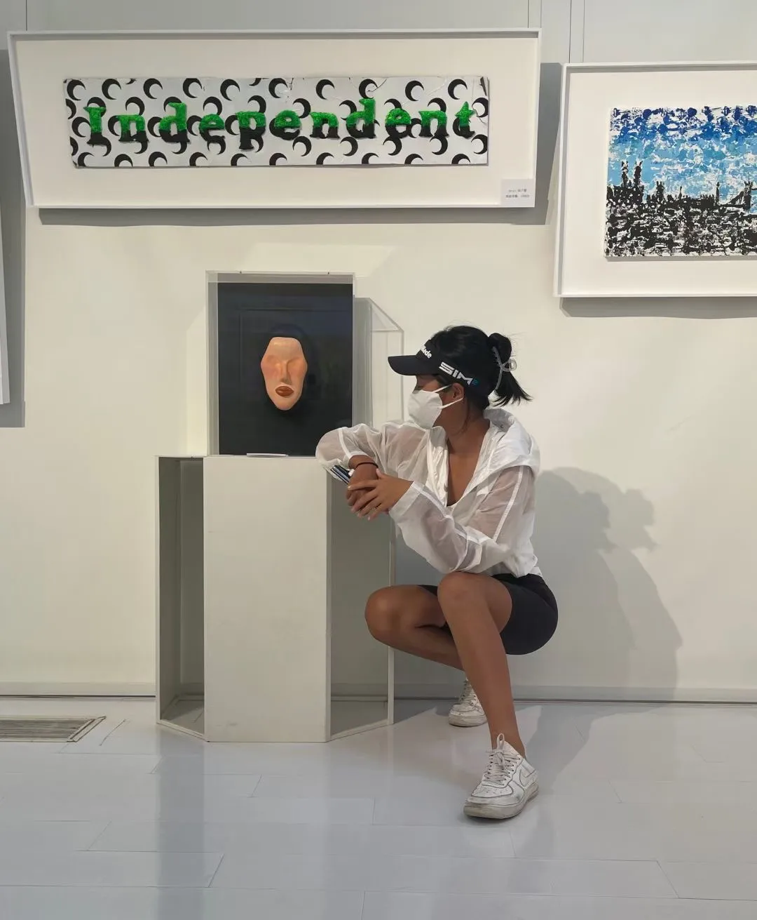 Ariel with her mixed-media works — Independent and the mask piece
